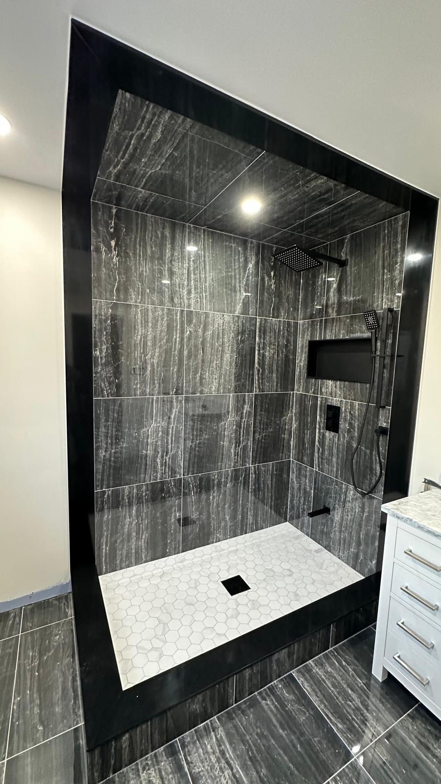 Shower tile and fixtures during installation, before the glass enclosure